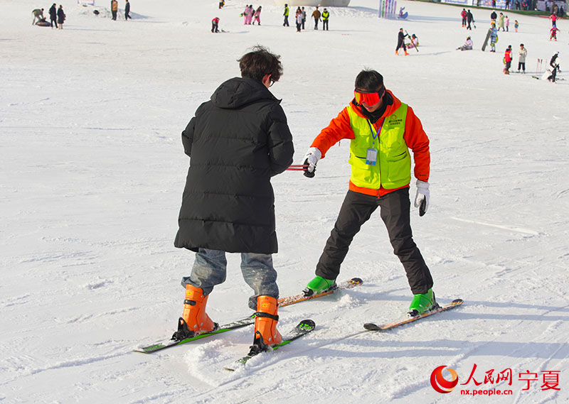 游客在宁夏银川市悦海滑雪场学习滑雪。人民网记者 梁宏鑫摄