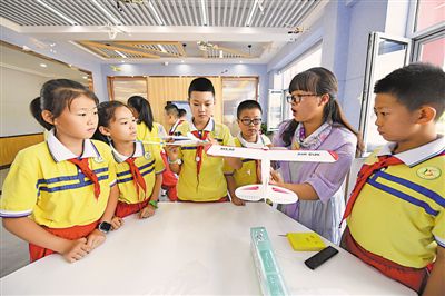 <p>    石嘴山市第十五小学的科学老师程丽鹏在新开设的纸飞机创客课程里，为学生们讲解空气动力学原理，小小飞机实现了孩子们飞向蓝天的梦想。					本报记者 王洋 摄</p>